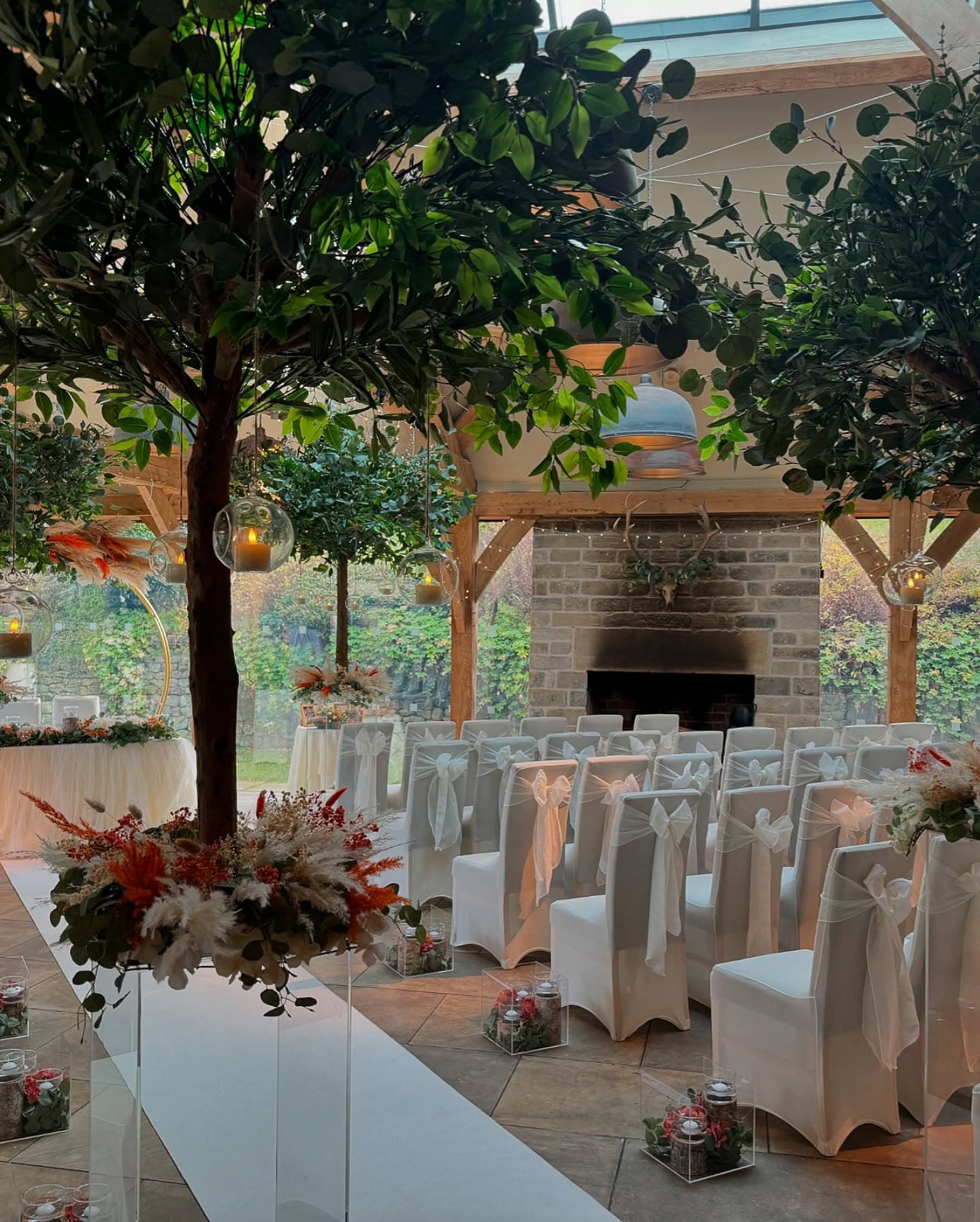 Wedding ceremony with hanging trees and pampas florals